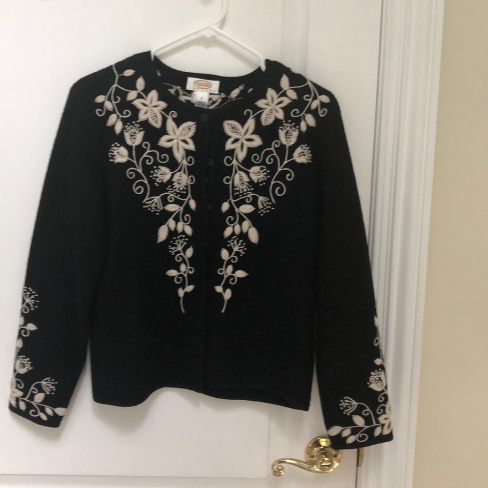 Black sweater-jacket type with white embroidery.